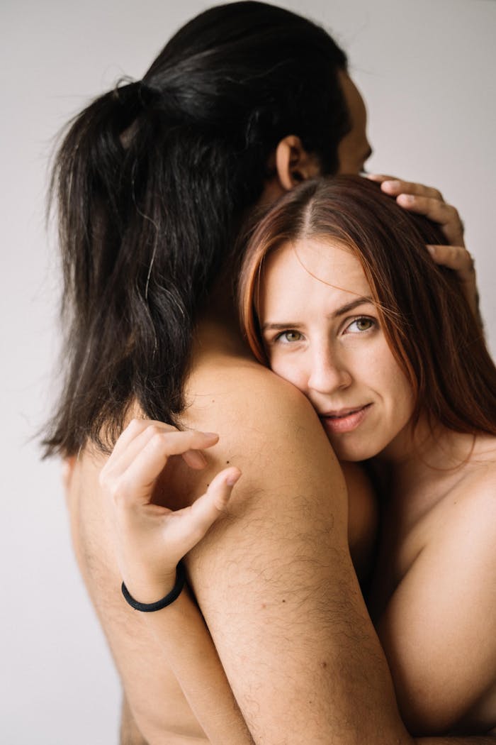 Long Haired Man Hugging the Topless Woman